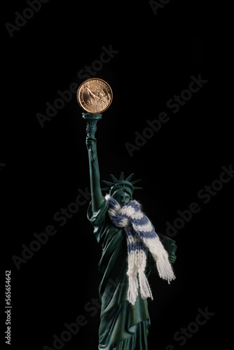 Statue of Liberty with a neck tied with a warm scarf and a coin in denomination of 1 American dollar instead of a torch © Max Zolotukhin