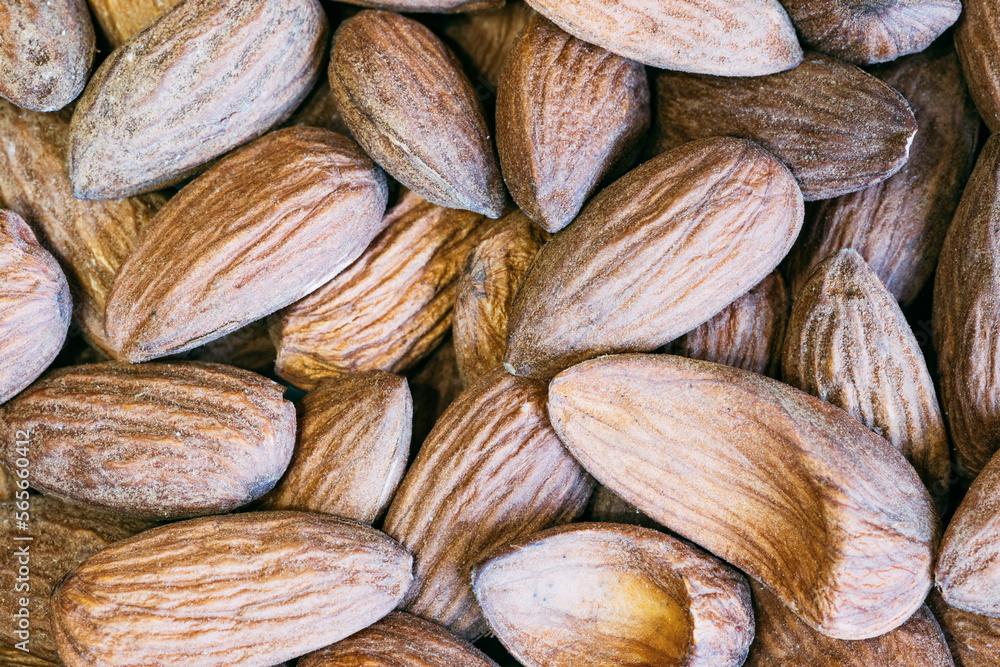 Fototapeta premium Almond nuts close. Background of almond nuts. Pile of almonds cl