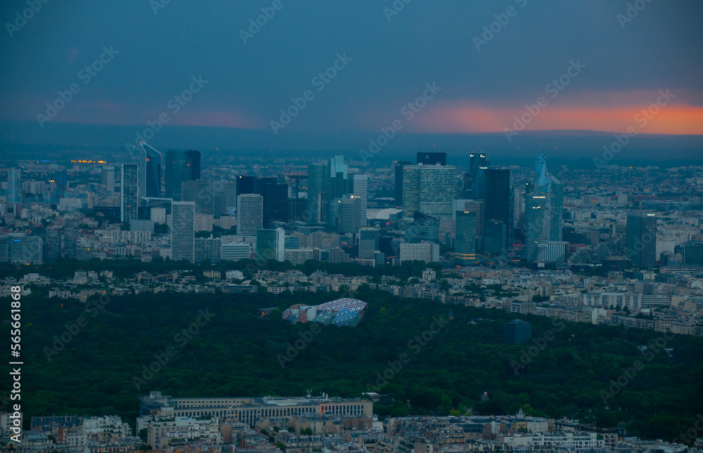The city of Paris, France taken from the Effile tower as the sun sets with rain falling in the background