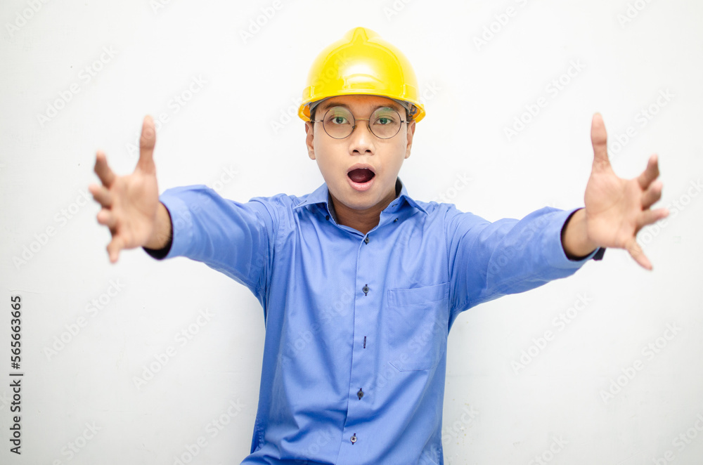 asian construction worker wearing yellow safety helmet and smiling and pointing finger with happy and shocked expression. billboard model advertisment concept. construction worker presenting something asian construction worker wearing yellow safety helmet and smiling and pointing finger with happy and shocked expression. billboard model advertisment concept. construction worker presenting something