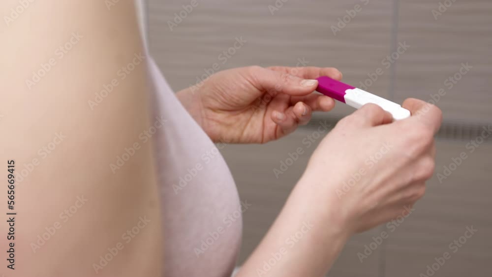 Pregnancy test in the hands of a young woman. Close-up. Pregnancy test in the hands of a young woman. Close-up.
