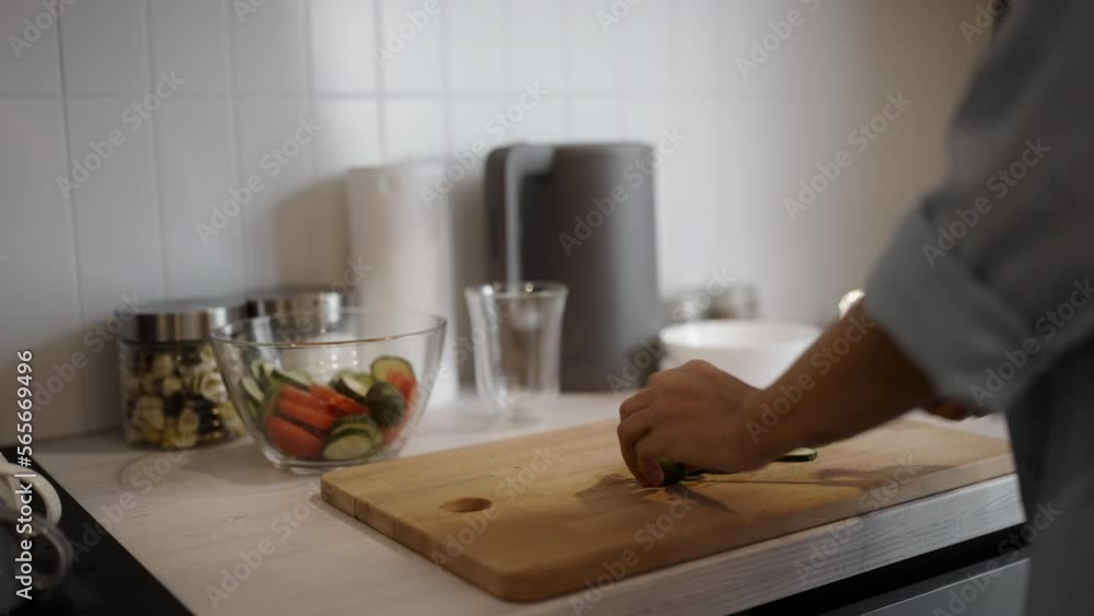 Woman cooking and serving salad on kitchen table, homemade food, culinary Woman cooking and serving salad on kitchen table, homemade food, culinary