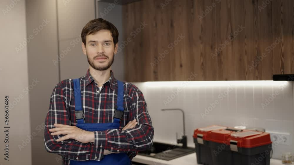 Portrait of confident repairman with crossed arms, home maintenance services Portrait of confident repairman with crossed arms, home maintenance services