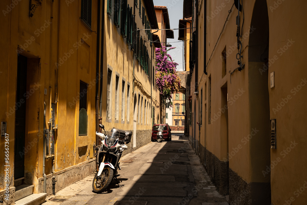 Street view of a classic Italian narrow alley in Pisa, Italy