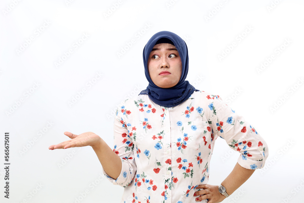 Confused asian muslim woman standing with doubt face expression and gesture. Isolated on white Confused asian muslim woman standing with doubt face expression and gesture. Isolated on white