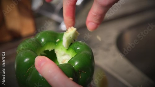 cleaning a green bell pepper from seeds and preparing to use for a stuffed peppers recipe 