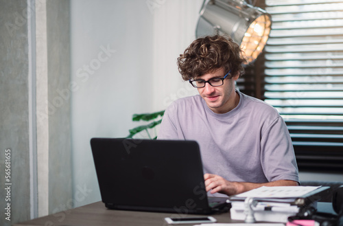Young caucasian man programmer wearing eyewear work in robotic coding project on laptop, Work at home concept.
