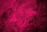 Black red rough surface. Toned old concrete wall.  Viva magenta color. Trend 2023. Close-up. Grunge background for design. Distressed, cracked, broken, crumbled, damaged, dilapidated. Backdrop.