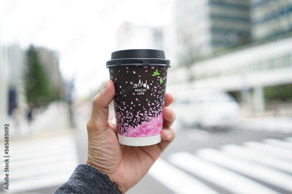 TOKYO, JAPAN - APR 05, 2018: Hand holding a sakura design black colour ...