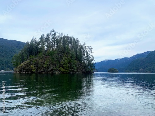 A beautiful winter view of Jug Island at the beach, at the end of Jug island trail, looking out at Indian Arm in Belcarra Regional Park, British Columbia, Canada photo