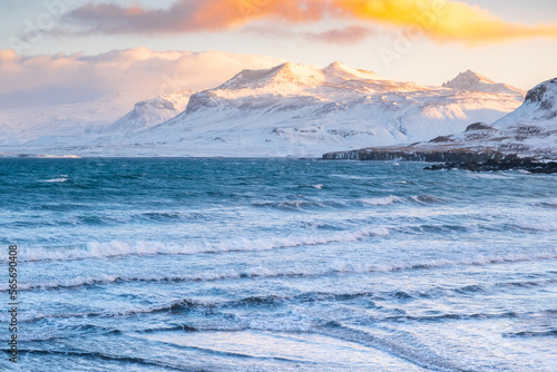 Seascape With Mountains in Winter  Sunset Fluffy Clouds and Stormy Sea  Iceland