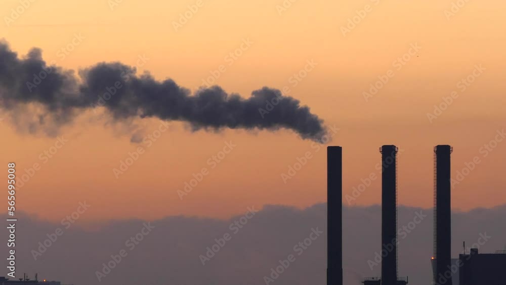 Copenhagen, Denmark Smokestacks from a power plant at dawn over the skyline emit steam.