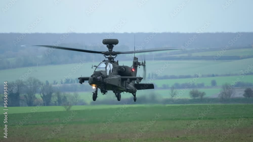 close-up front view of British army AH-64E Boeing Apache Attack helicopter gunship ZM722 ArmyAir606, AH64E in a low hover on a military exercise, Wilts UK close-up front view of British army AH-64E Boeing Apache Attack helicopter gunship ZM722 ArmyAir606, AH64E in a low hover on a military exercise, Wilts UK