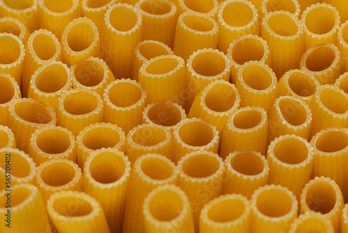 Rigatoni. Tube-shaped italian pasta. Edges close-up. Selective focus.