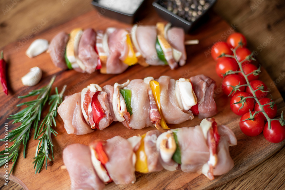 Raw meat skewers with vegetables on wooden background Raw meat skewers with vegetables on wooden background