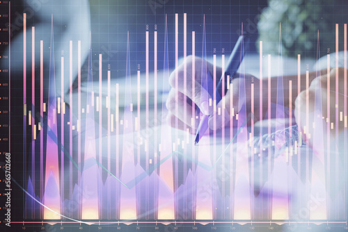 Financial forex graph displayed on hands taking notes background. Concept of research. Multi exposure © peshkova