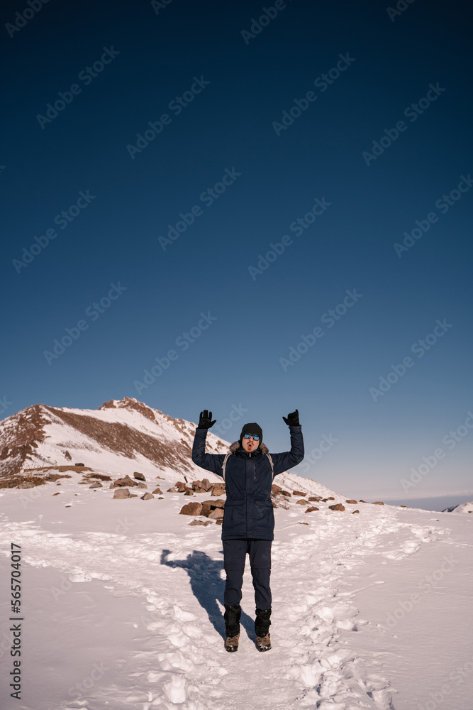 happy guy on the background of a winter landscape in the mountains