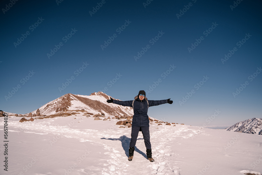 happy hiker in the mountains smiling with arms outstretched to the sides
