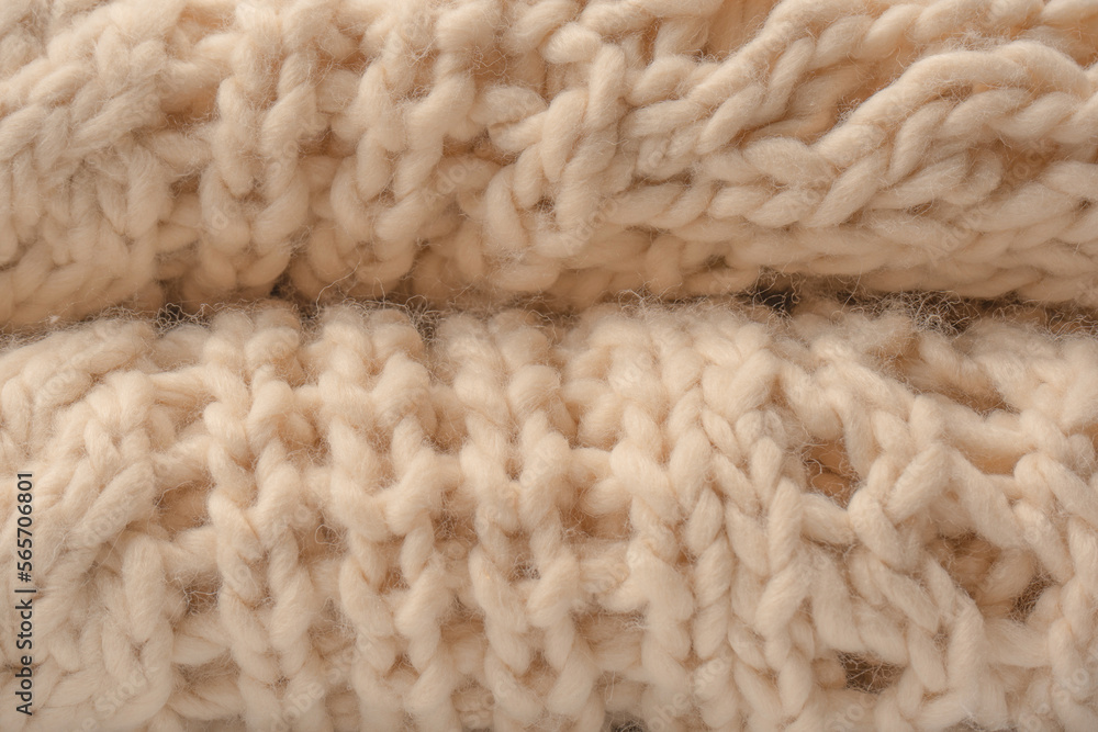 A fragment of beige knitted fabric, knitted from white sheep wool. A fragment of beige knitted fabric, knitted from white sheep wool.