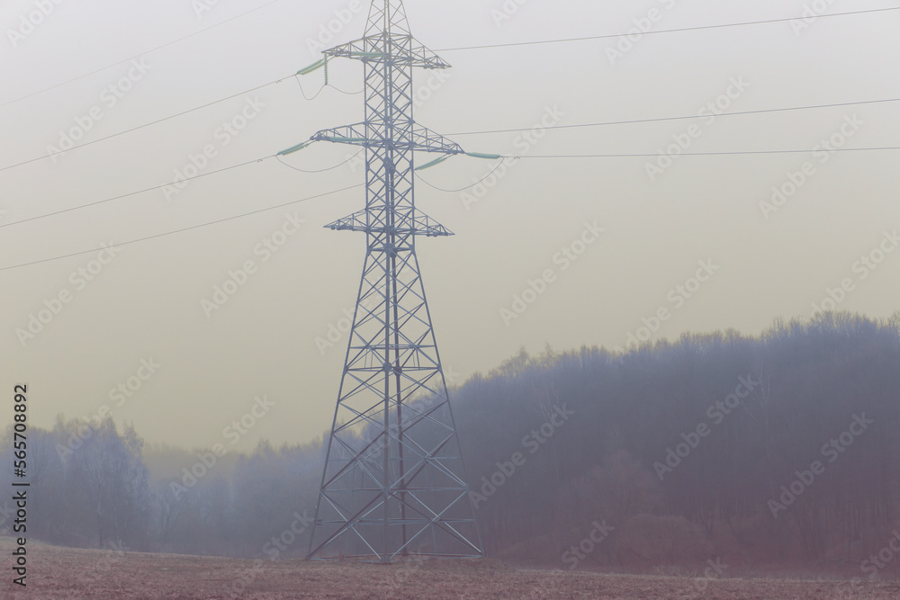 Power lines on the field in the park. Gloomy misty autumn day. Power lines on the field in the park. Gloomy misty autumn day.