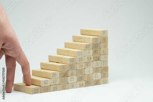 Human hand climbing stairs on white background, concept for growth in life. Career ladder. Professional development, aims achievement, path to prosperity, hard path to award. Making the first step.