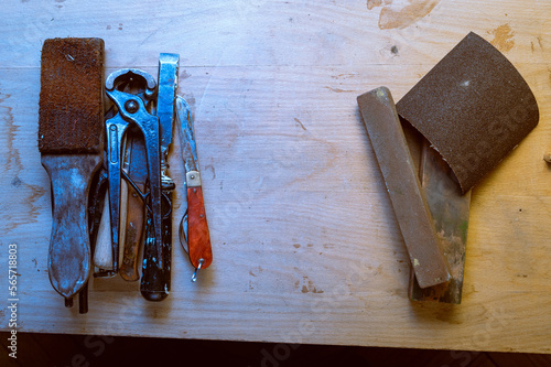 Old tools on the table. Tools for repair. Workshop and service. Tools for cleaning and sharpening. photo