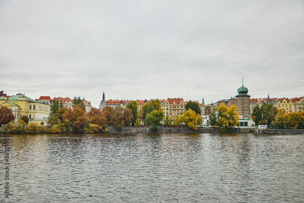 Wide view of architecture in Prague. We see colorful buildings, Vltava river and autumn trees. Wide view of architecture in Prague. We see colorful buildings, Vltava river and autumn trees.