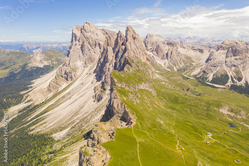 Drone photography of dolomite mountain range and mountain meadow