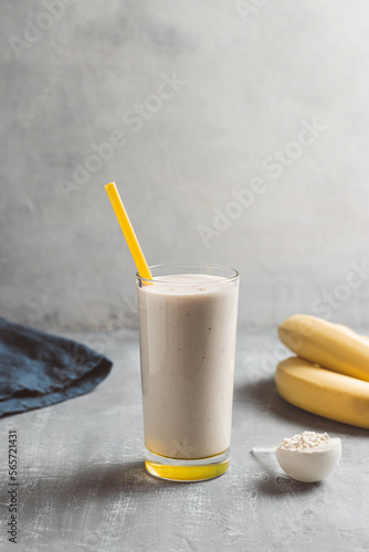 Banana smoothie with protein powder in a glass, healthy eating concept