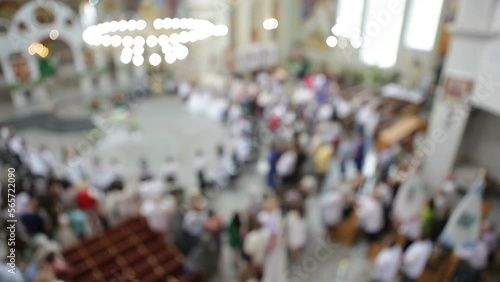 The children take the first communion. Church liturgy. Blurry fuzzy video. View from above.