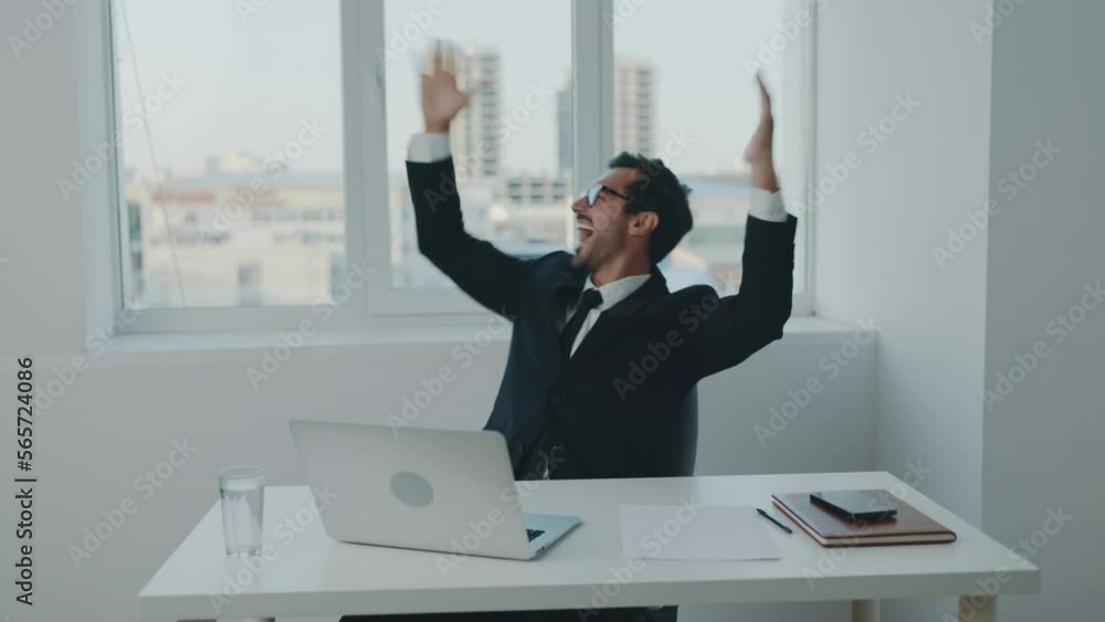 Man business smile and happiness dance winner, successful news, working in office at laptop, workday and paperwork, technology and online. Man business smile and happiness dance winner, successful news, working in office at laptop, workday and paperwork, technology and online.