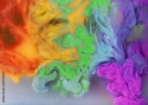 Splash of rainbow colors inks on grey background