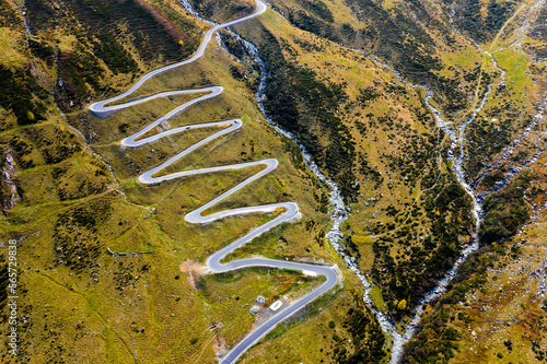 Aerial View of Winding Mountain Road in Alps
