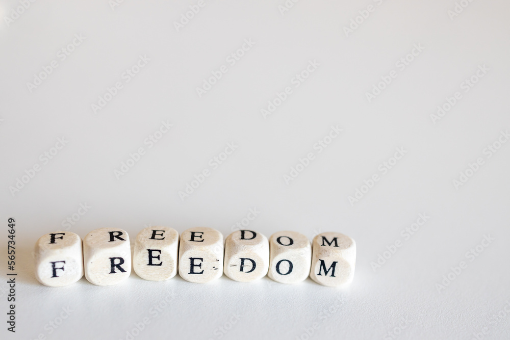 Word freedom made up of wooden cubes isolated on white background Word freedom made up of wooden cubes isolated on white background