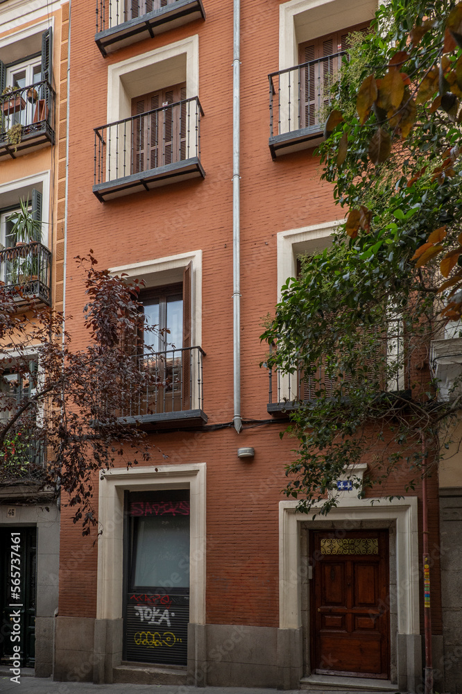 Brick facades of a narrow old building in a pedestrian street in the center of Madrid in the Barrio de las Letras
