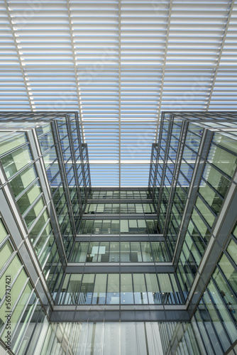 Low angle view of an office building facade built with a lot of steel and glass