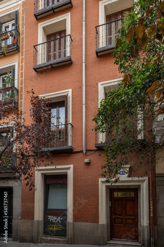 Brick facades of a narrow old building in a pedestrian street in the center of Madrid in the Barrio de las Letras