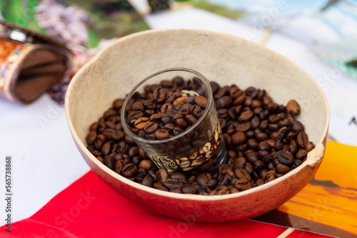 A clear glass cup filled with coffee beans, perfect for enjoying a hot coffee while admiring the beans. The unique design makes this glass a true work of art for coffee lovers.