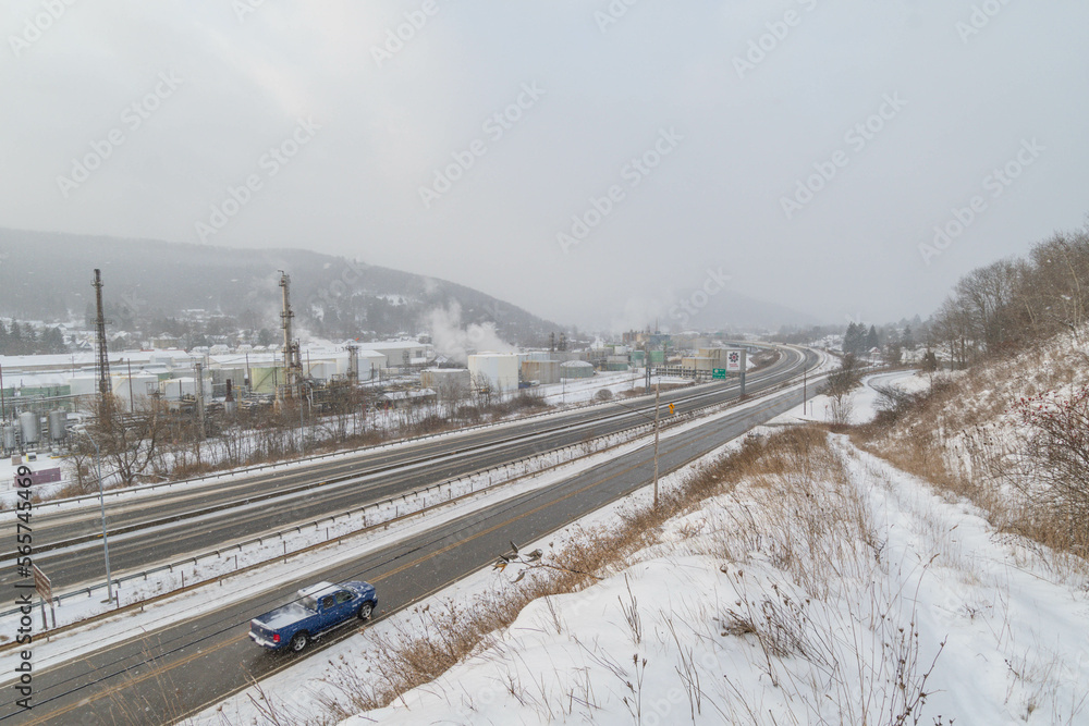 Mountain town highway road and oil plant during snow weather, travel USA town