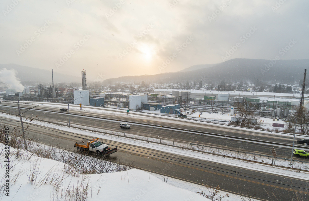 Mountain town highway road and oil plant during snow weather, travel USA town