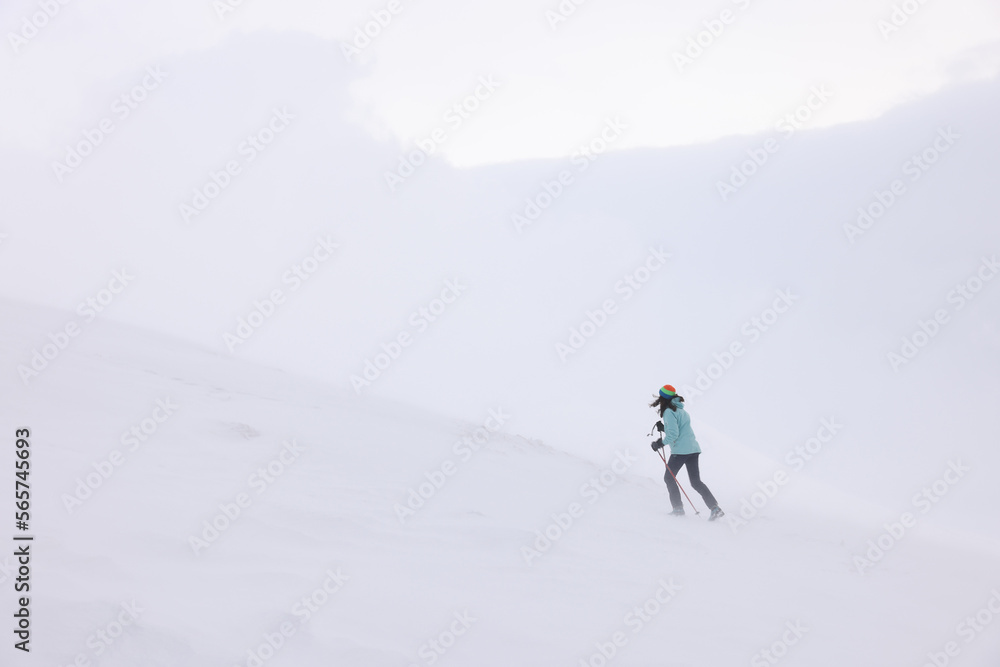 Winter mountain climbing in harsh blizzard conditions, Parng Mountains, Romania, Europe