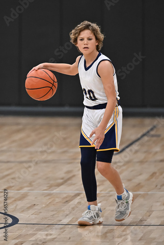 Young boy playing in a competitive youth basketball game