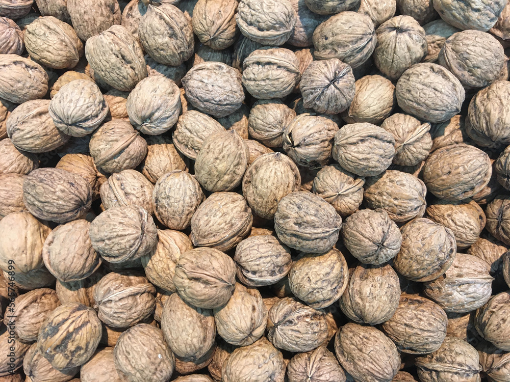 Heap of nuts inside a box, background, texture of nuts, dried fruit Heap of nuts inside a box, background, texture of nuts, dried fruit
