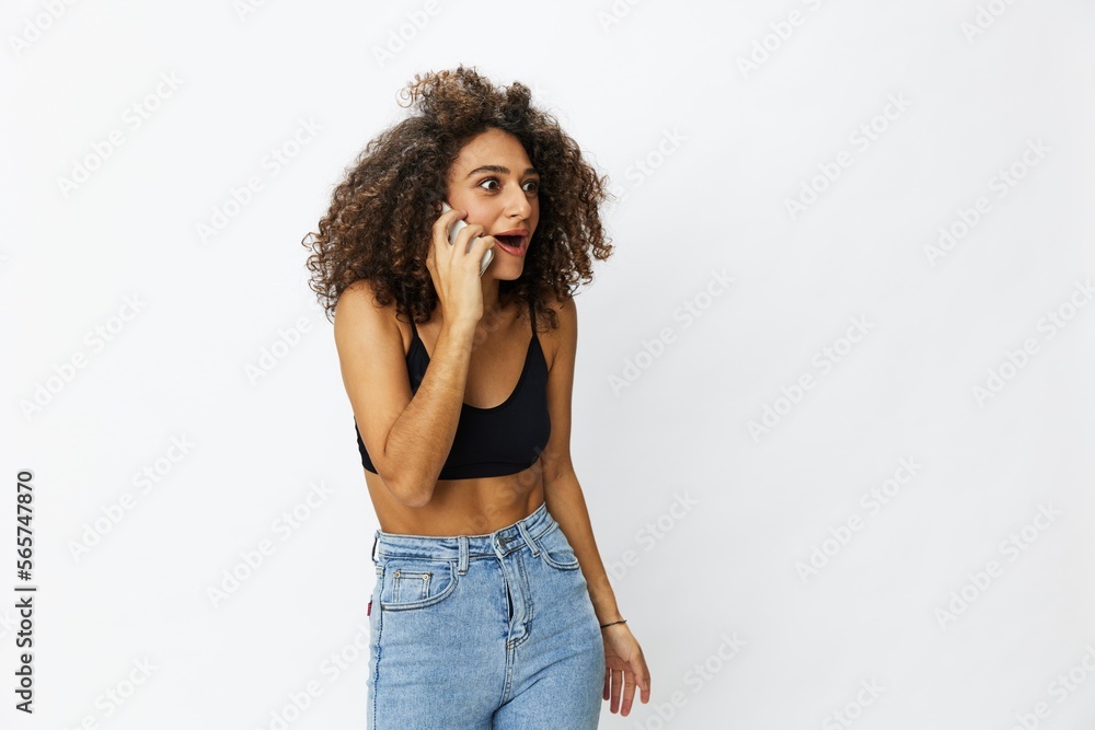 Woman blogger with phone in hand on white background selfies, video call, freelancer influencer job in social media and media, technology for work, smile curly hair copy spot Woman blogger with phone in hand on white background selfies, video call, freelancer influencer job in social media and media, technology for work, smile curly hair copy spot