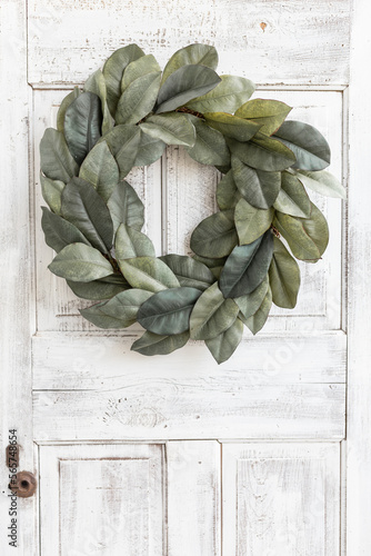 Magnolia wreath on an antique white door