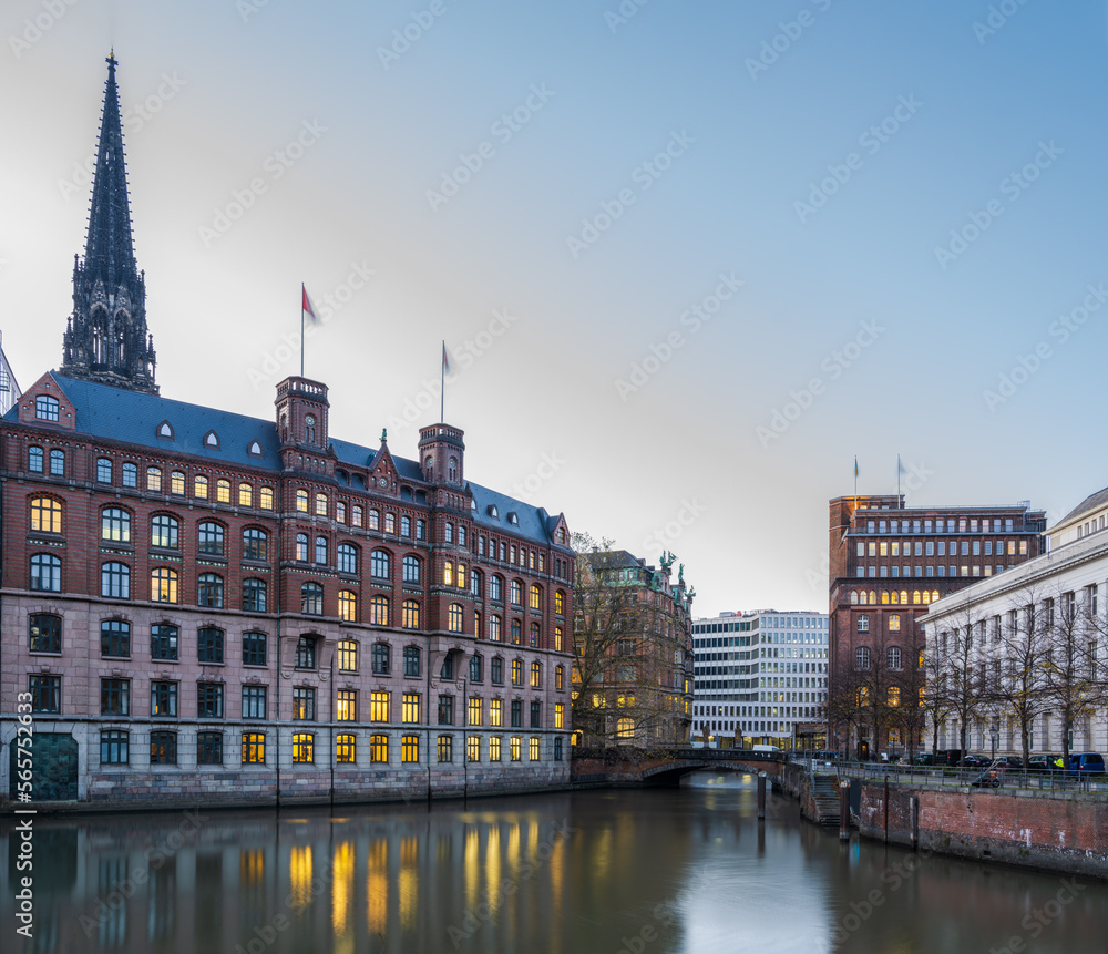 Fototapeta premium Historic and modern buildings at dusk with light reflection on the canal in Hamburg, Germany
