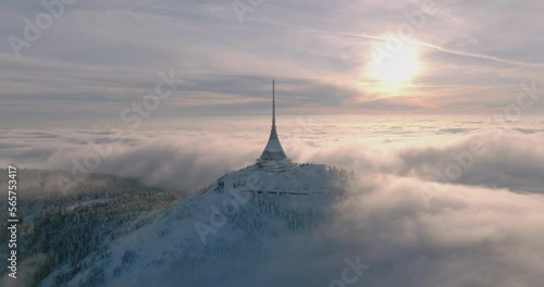 Jested tower mountain hill with snow mist and fog at golden hour