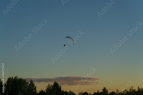 paragliding training silhouette of a paraglider in the air against the background of the evening sky at sunset 