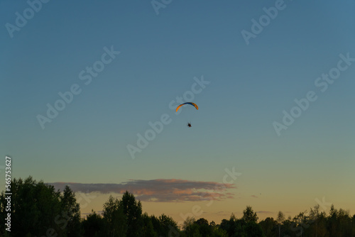 paragliding training silhouette of a paraglider in the air against the background of the evening sky at sunset