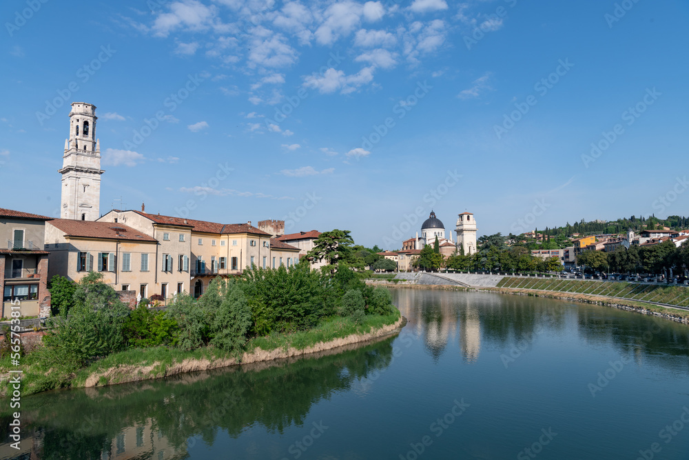 view looking up the Fiume Adige towards the St Giorgio church in Verona Italy